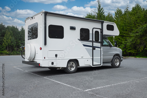 A motor home camper ready to holidays near lake or river in road trip vacation