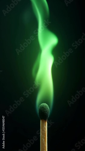 A striking image of a matchstick ignited, emitting vibrant green smoke against a dark background, capturing the essence of fire and movement.