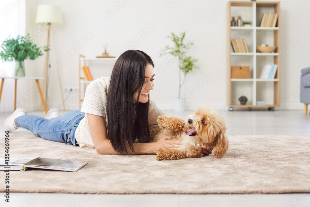 custom made wallpaper toronto digitalPortrait of young happy smiling female owner playing with her little cute dog lying on floor in the living room at home enjoying leisure together. Cheerful woman with her pet indoors. Animal concept.