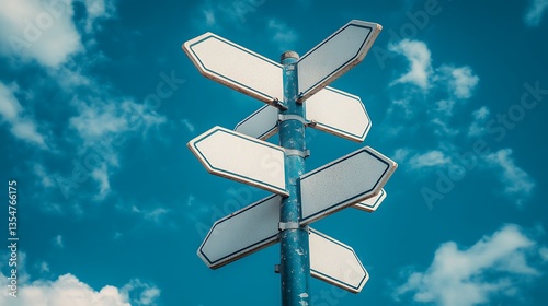 Blank signpost against blue sky.