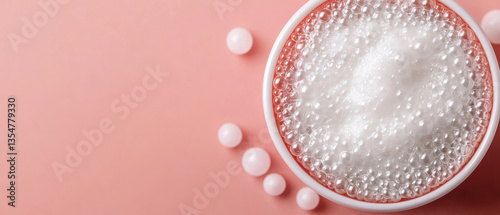 foamy anti aging treatment in bowl, surrounded by small white pearls, evokes sense of luxury and rejuvenation