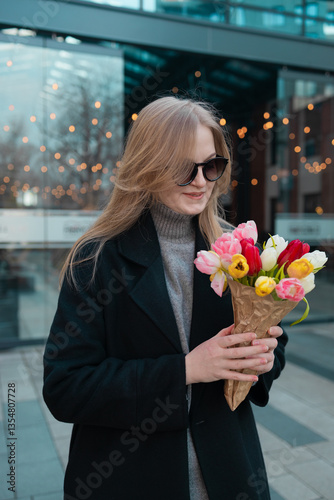 Obraz na płótnie Beautiful happy Caucasian woman smelling bunch of tulips with closed eyes. High quality w salonie