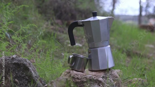 Aluminum coffee maker with aluminum cup in a forest, camping