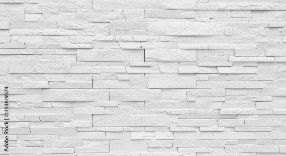 Obraz premium A clean, textured white stone wall composed of various rectangular stones arranged in an interesting pattern. Ideal for backgrounds, interior design inspiration, and modern aesthetics.