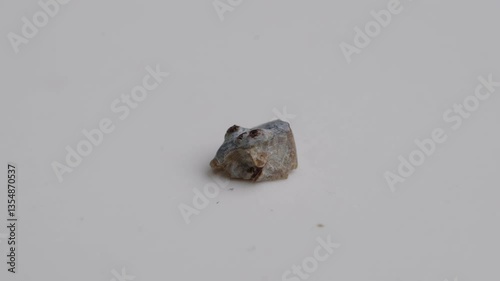 Kidney stone fragments broken up by ultrasonic waves on a rotating table
