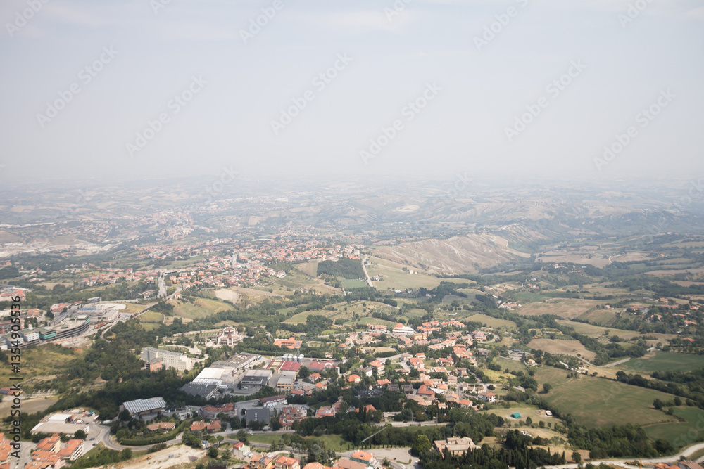Fototapeta premium An awe-inspiring aerial view of San Marino, capturing the layout of the city and its picturesque surroundings from above.