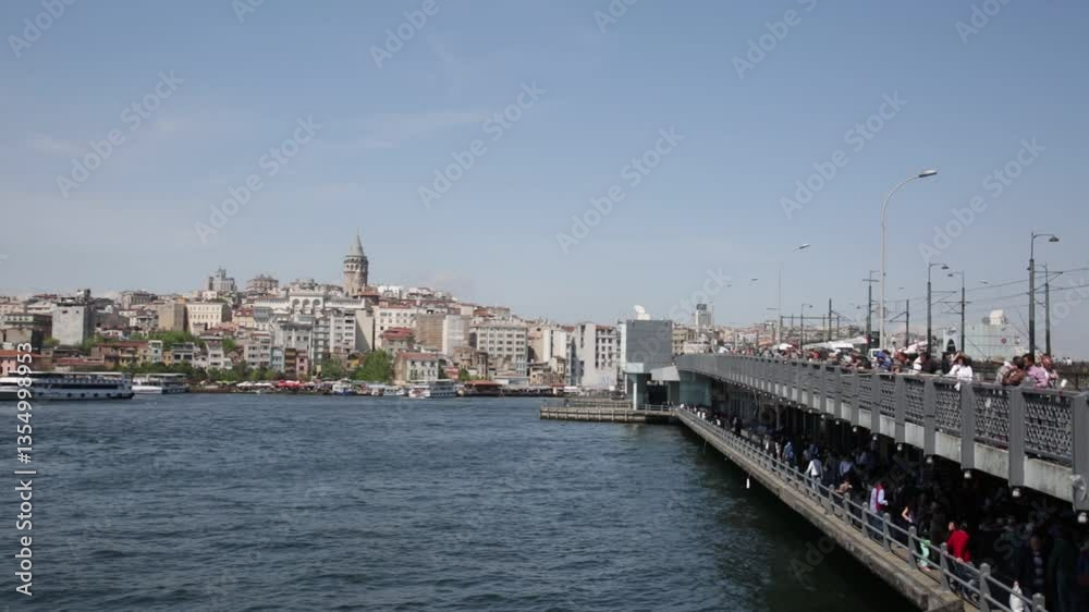 TURKEY, ISTANBUL - MAY 15, 2015: Galata Bridge and mosque Eminonu ( New Mosque) in the evening. Galata Bridge (Galata Koprusu) - the bridge through a bay the Gold Horn. TURKEY, ISTANBUL - MAY 15, 2015: Galata Bridge and mosque Eminonu ( New Mosque) in the evening. Galata Bridge (Galata Koprusu) - the bridge through a bay the Gold Horn.