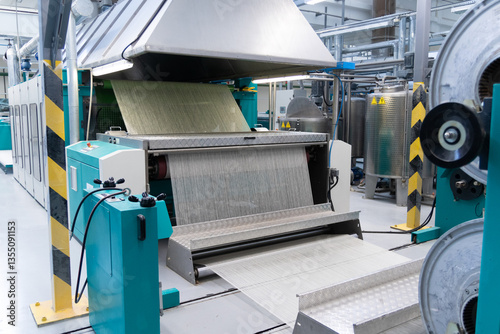 Industrial fabric production line. Looms in a textile factory