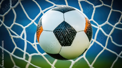 Close-Up of a Soccer Ball Nestled in a Goal Net with a Blur Background of the Field