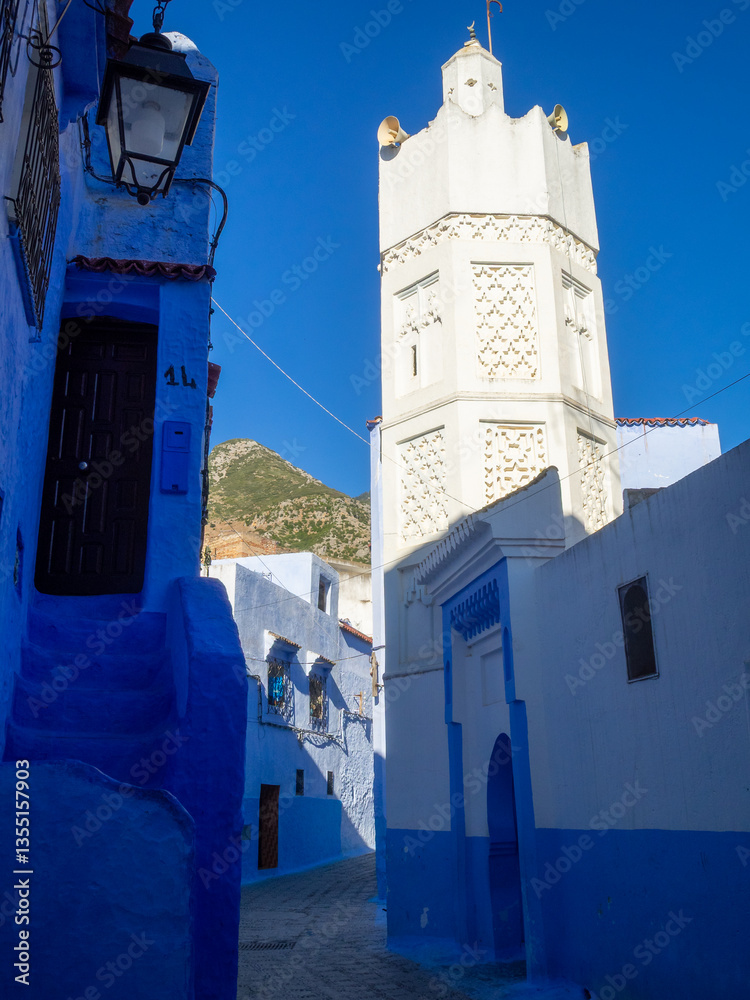 The White Mosque of the Souk minaret above the indigo houses of Chefchaouen, Morocco