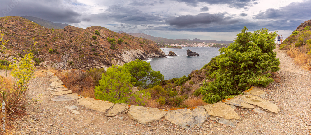 Rocky hiking path overlooking Cadaques in Catalonia, Spain with cliffs and the Mediterranean Sea