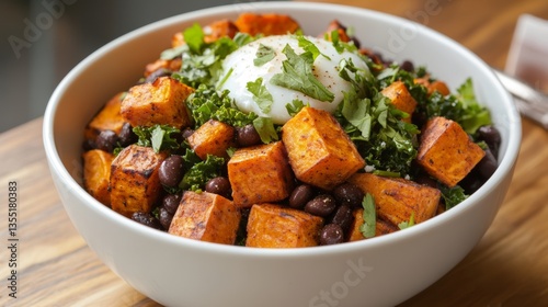 Sweet potato breakfast hash with sautéed kale, black beans, and a poached egg offers a nutritious morning start