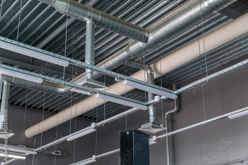 Heating pipe system in the warehouse of the enterprise. ceiling blower system. lighting lamps
