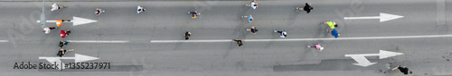 Aerial photo of a group of people running in one direction together.