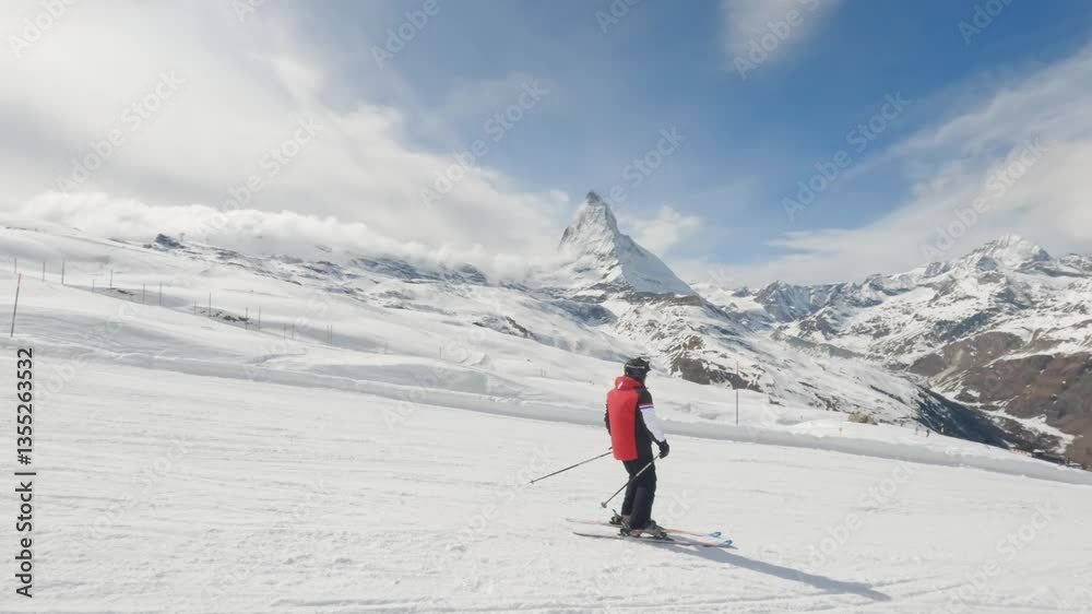 Skier Skiing in Zermatt Ski Resort with Matterhorn Mountain Peak View