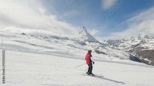 Skier Skiing in Zermatt Ski Resort with Matterhorn Mountain Peak View
