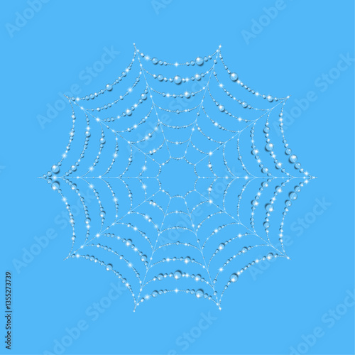 Cobwebs glisten in water droplets on an blue background