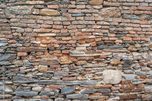 Brick wall with some stones in it