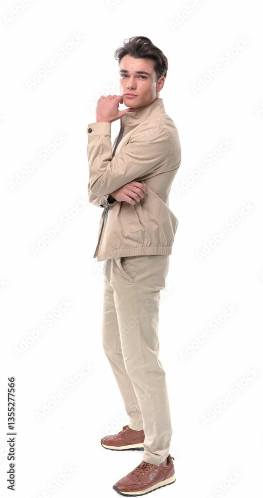 side view of cool casual guy holding hands in pockets, crossing arms, touching chin and thinking, walking away in front of white background side view of cool casual guy holding hands in pockets, crossing arms, touching chin and thinking, walking away in front of white background