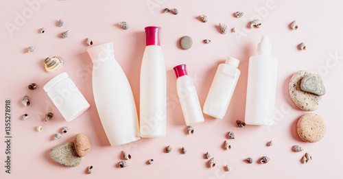Set of various cosmetic bottles for feminine care on pink top view web banner