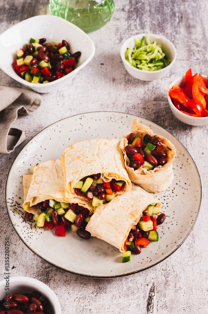 Vegetarian salsa rolls in tortilla on plate on table vertical view
