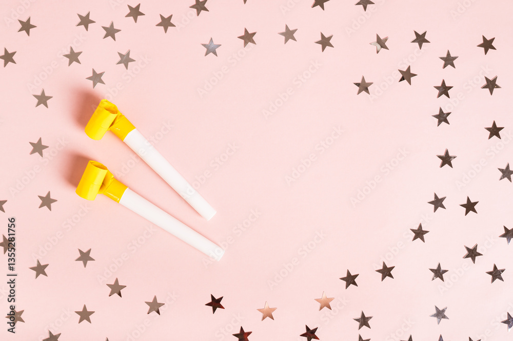 Happy April Fools' Day whistles and stars on pink top view copy space