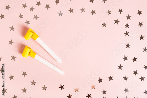 Obraz na płótnie Happy April Fools' Day whistles and stars on pink top view copy space w salonie