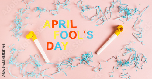 Obraz na płótnie April Fools' Day from colored letters, whistles, balloons and paper on pink top view web banner w salonie