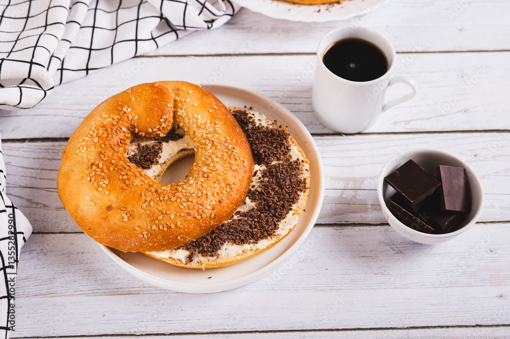 Sweet sandwich with butter, chocolate and sesame seeds on a plate on a table
