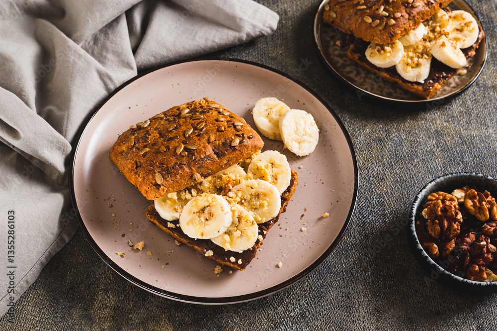 Toast rye bread with chocolate and banana on a plate on the table