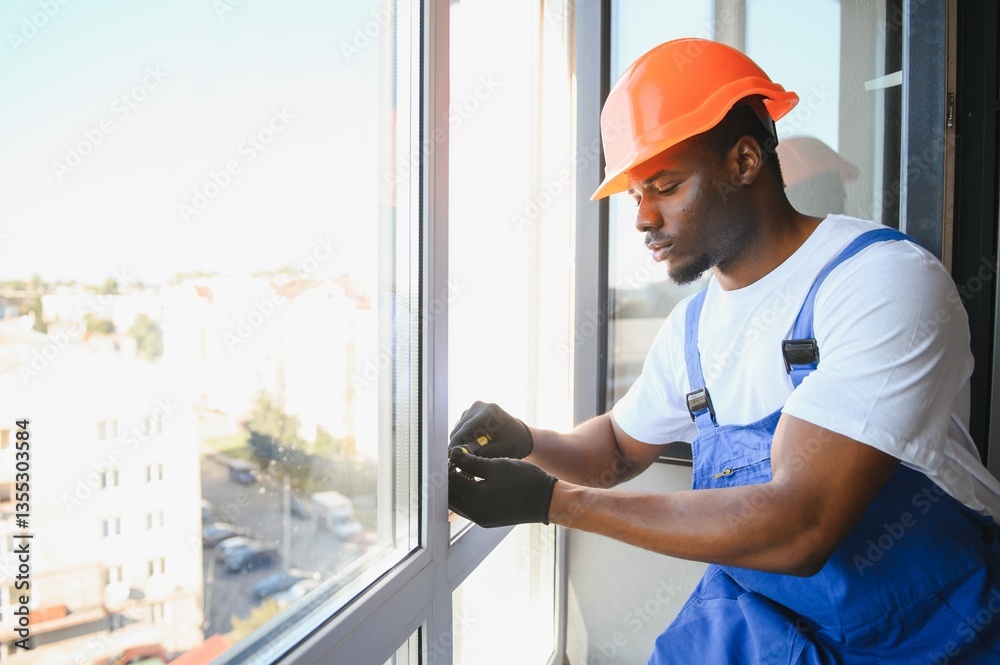Worker in installing white plastic upvc window on house Worker in installing white plastic upvc window on house