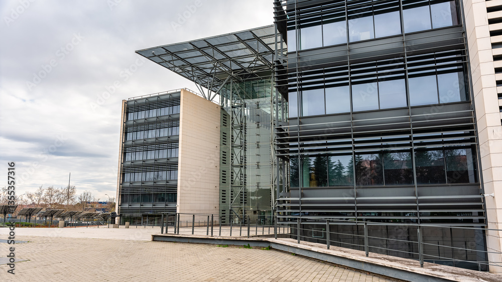 Steel and glass buildings in the office area of the capital Madrid next to the M40 road.