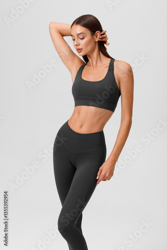 Fitness woman. Athletic girl on the gray background