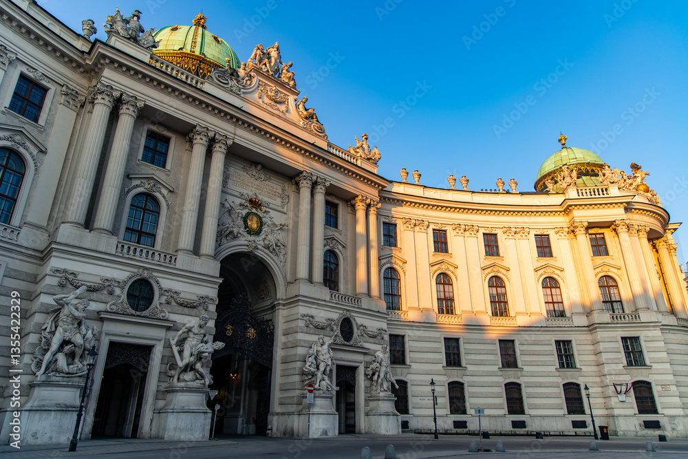 Fototapeta premium Michaelertrakt entrance of Hofburg Palace shining in morning sunlight, Vienna, Austria