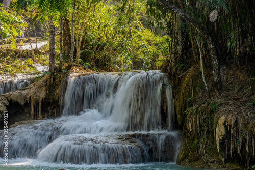 Lush Tropical Cascade at Kuang Si Falls with Crystal Clear Water and Dense Jungle near Luang Prabang, Laos