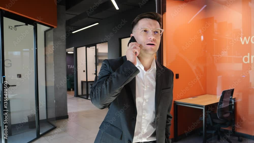 custom made wallpaper toronto digitalMan in suit engages in phone conversation inside stylish office space.