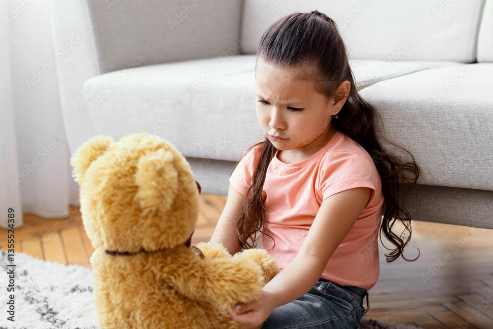 Lonely Kid. Sad Asian Girl Sitting With Teddy Bear Toy Suffering From Loneliness Alone At Home. Lonely Kid. Sad Asian Girl Sitting With Teddy Bear Toy Suffering From Loneliness Alone At Home.