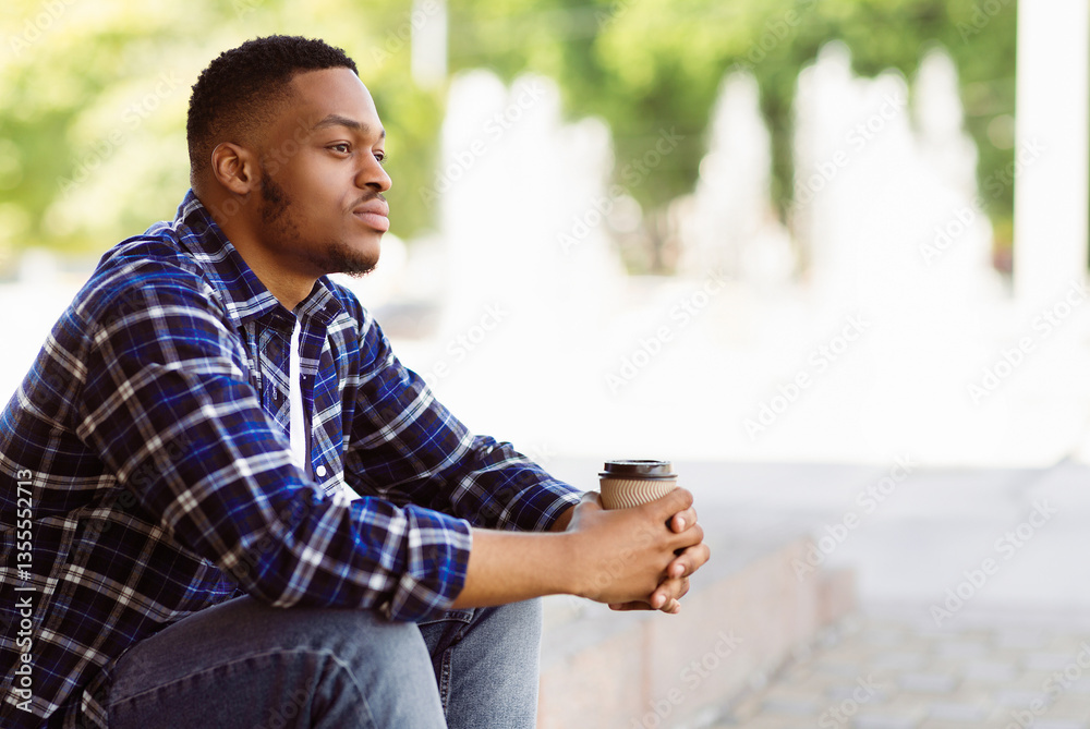Fototapeta premium Side view of pensive african american person sitting in the park with coffee, looking aside, free space