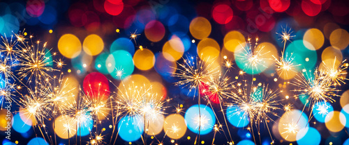 sparklers against colorful ...