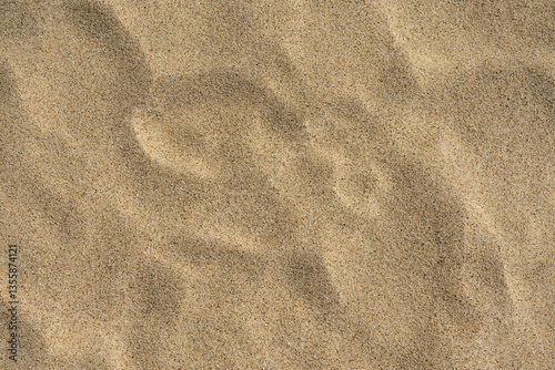 Uneven sand texture, beach background, top down view 