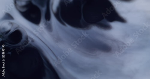 Wet texture. Stains art. Defocused blue color chemical water sparkling paint in liquid wave moving on abstract dark black background.