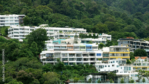 Colorful residential buildings nestled in lush green mountainside