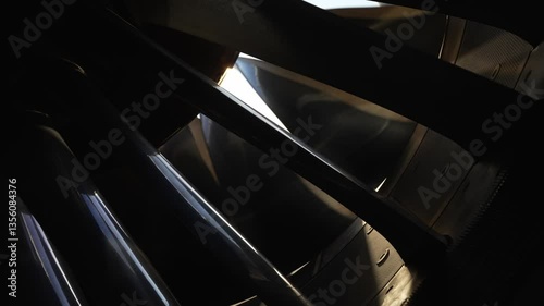 GEnx turbine engine fan blades spinning as sun shines between the fan blades