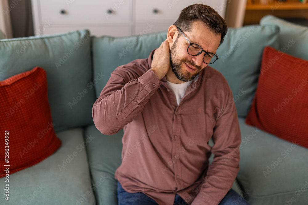 Handsome man touching his neck, suffering from neck pain, sciatica, sedentary lifestyle concept. neck health problems. Healthcare, insurance Handsome man touching his neck, suffering from neck pain, sciatica, sedentary lifestyle concept. neck health problems. Healthcare, insurance