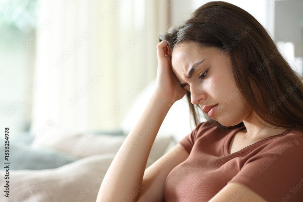 Sad woman feeling alone complaining at home Sad woman feeling alone complaining at home