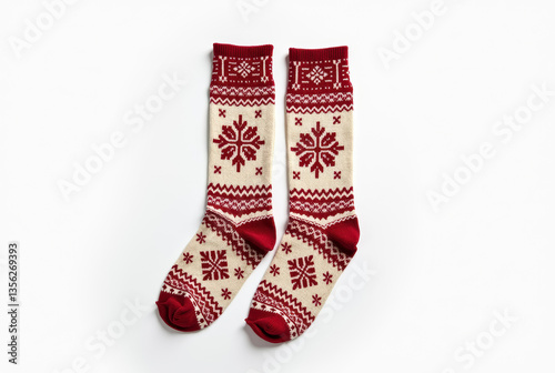 Cozy winter socks with traditional Nordic pattern on white background.