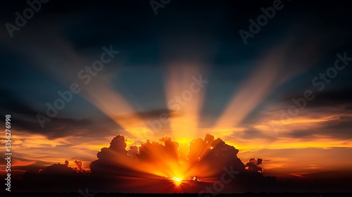 Dramatic sunset rays through clouds photo