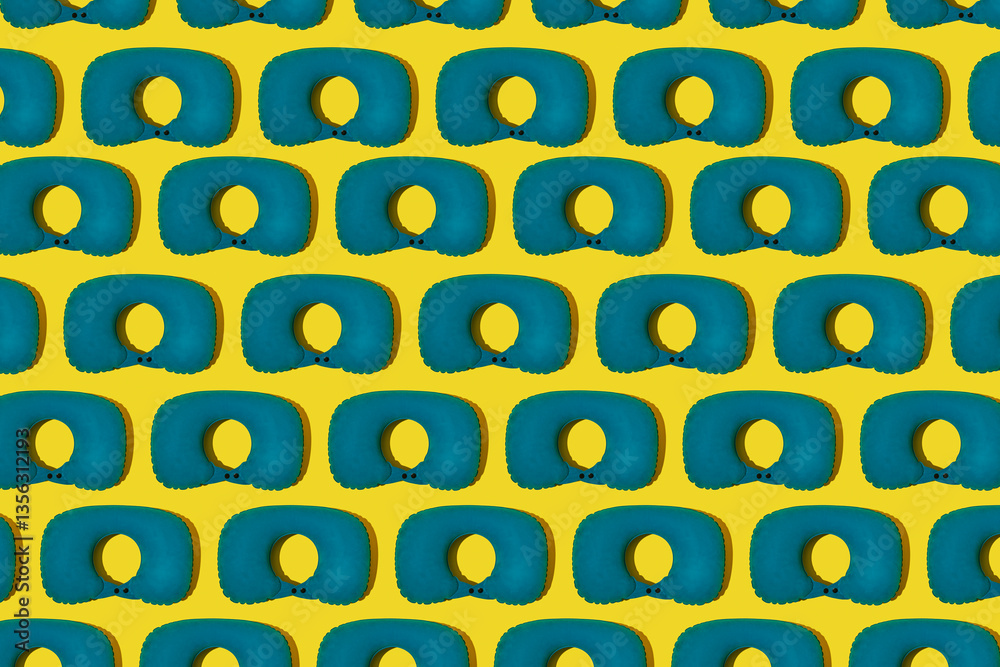 Pattern of blue inflatable travel pillows on a yellow background