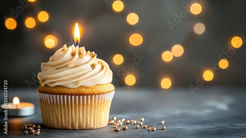 Delicious vanilla cupcake with creamy frosting and candle light