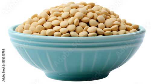 Light yellow nutritional yeast flakes overflowing from an aqua colored bowl